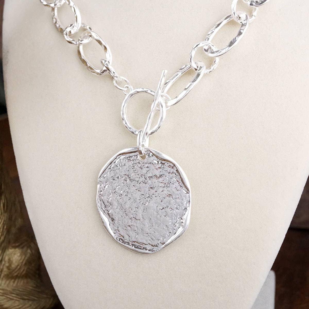 Nomad Glow – Front Toggle Statement Necklace with Hammered Disc: Worn Silver Tone