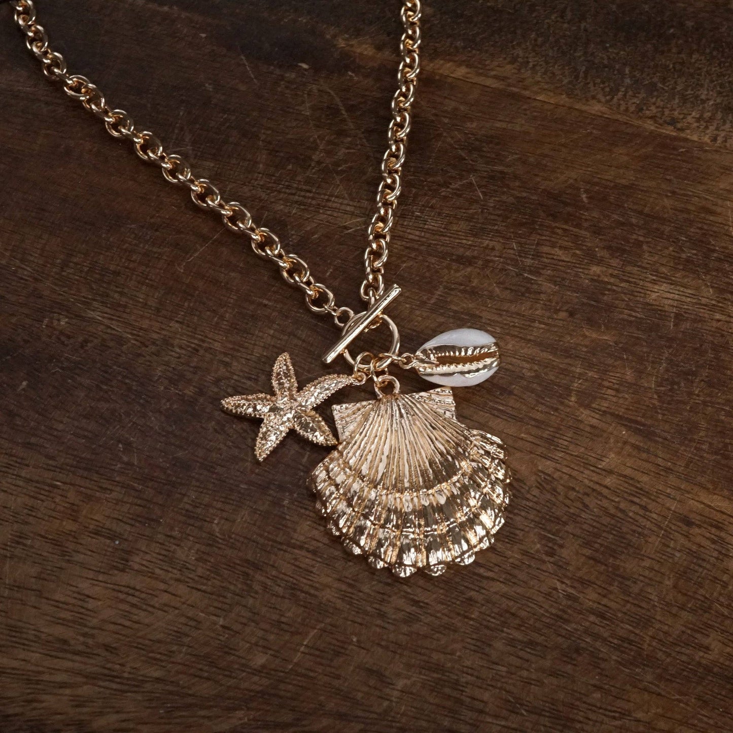 Front Toggle Multi-Charm Shell Statement Necklace – Gold Tone