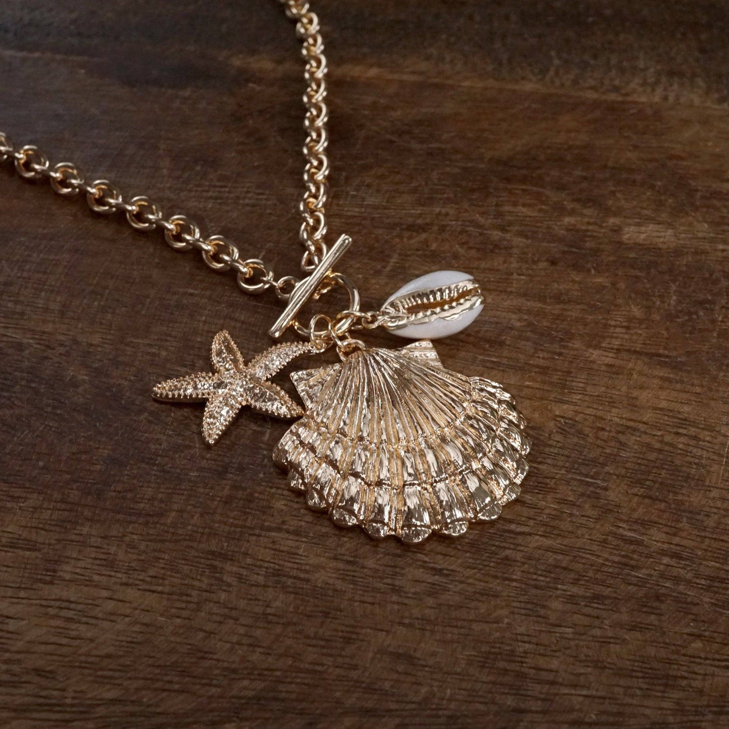 Front Toggle Multi-Charm Shell Statement Necklace – Gold Tone